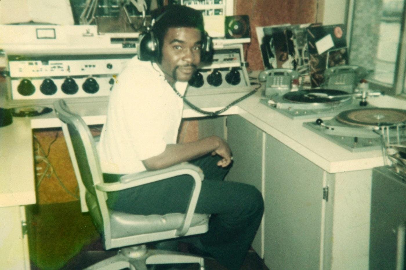 Robert L. Scott in a radio booth wearing headphones