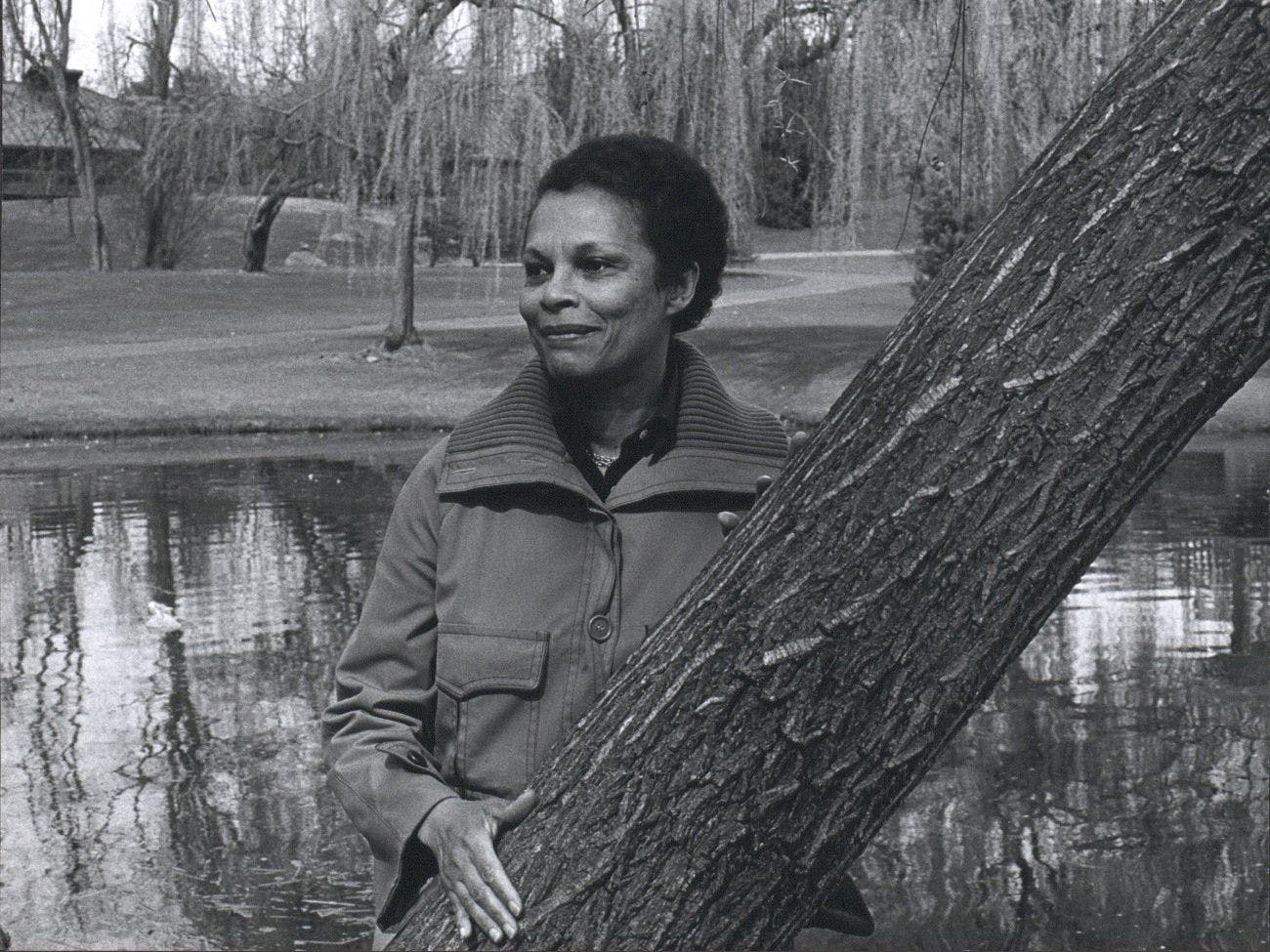 Gwendolyn Knight stands near a tree in a park