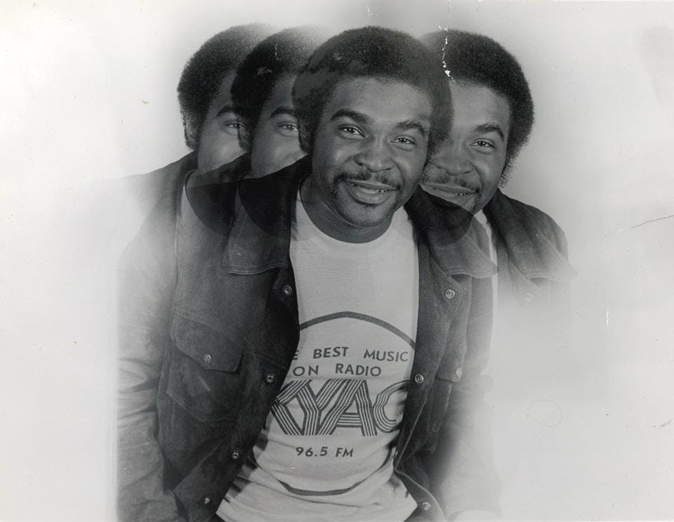 A 1970s multiple-exposures portrait of Robert L. Scott wearing a jean jacket and a KYAC t-shirt