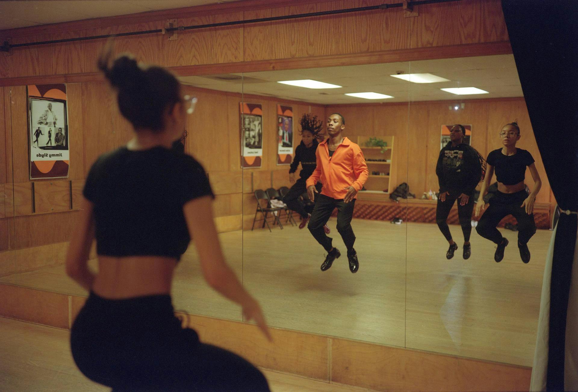 Cipher Goings and several of his students dance in front of the mirror in the Northwest Tap Connection studio.