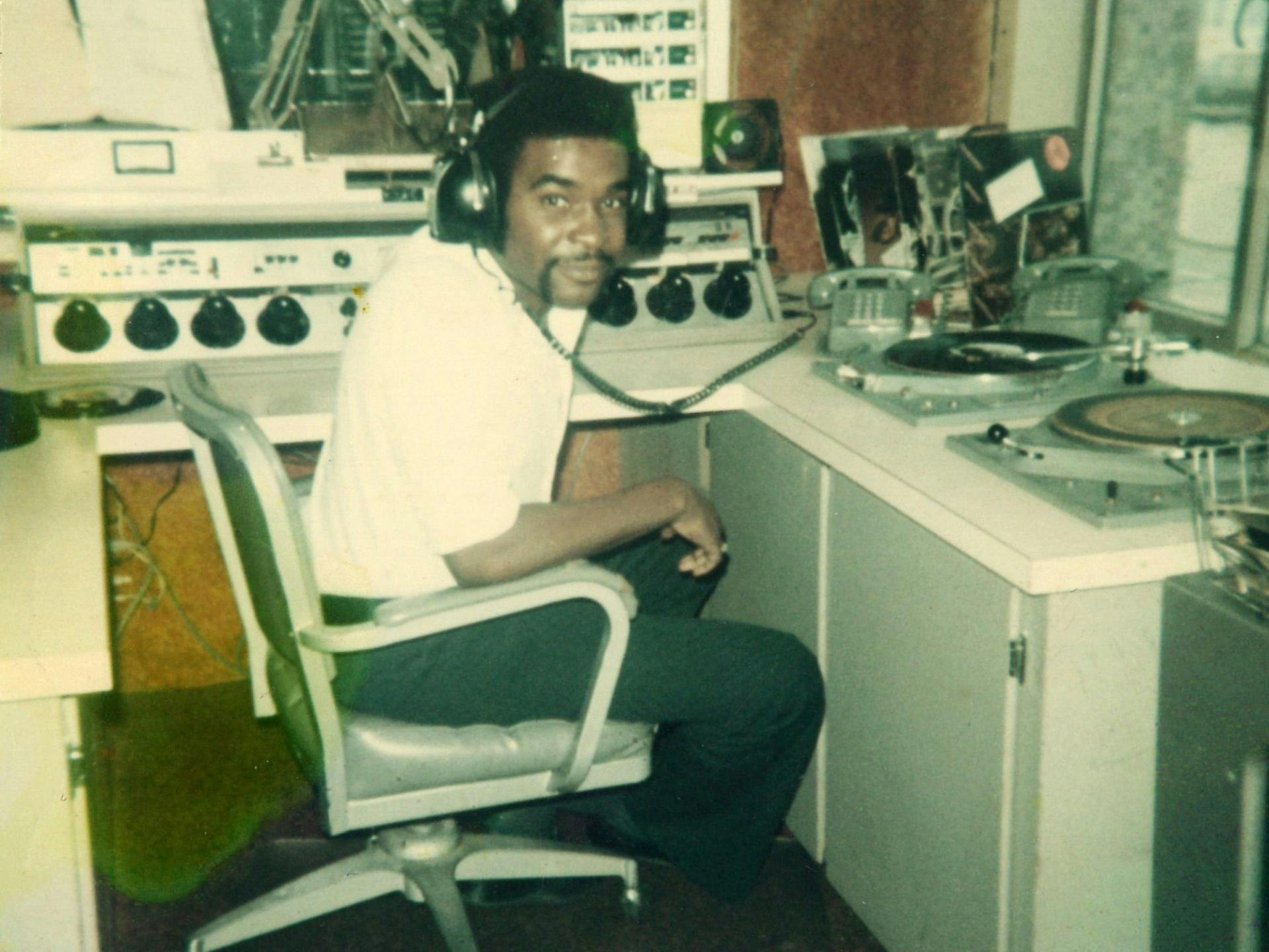 Robert L. Scott in a radio booth wearing headphones