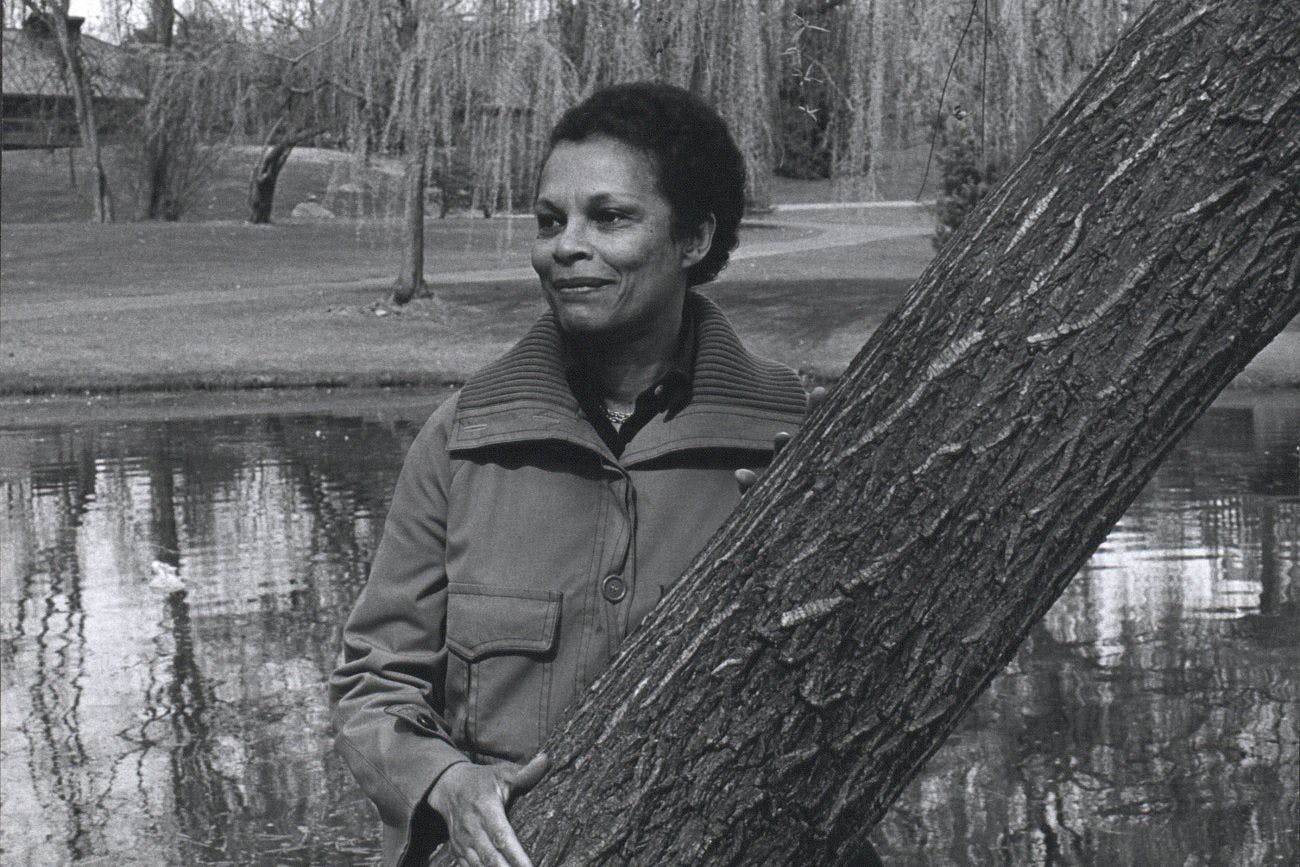 Gwendolyn Knight stands near a tree in a park