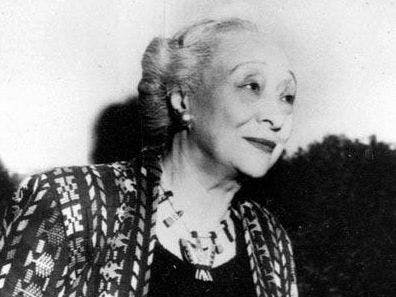 A black and white image of an older woman looking off camera right