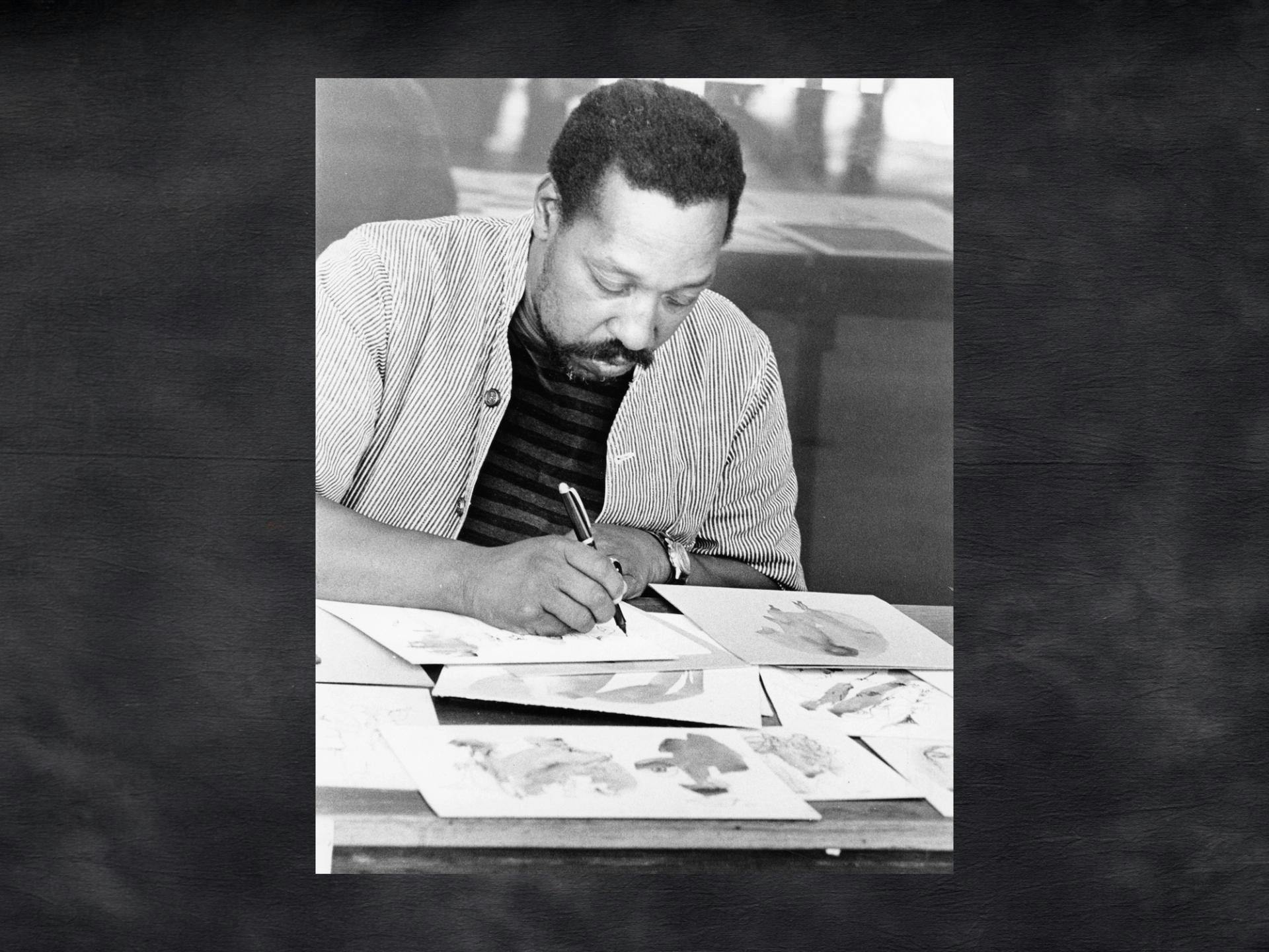 A vintage black and white photo of a man drawing