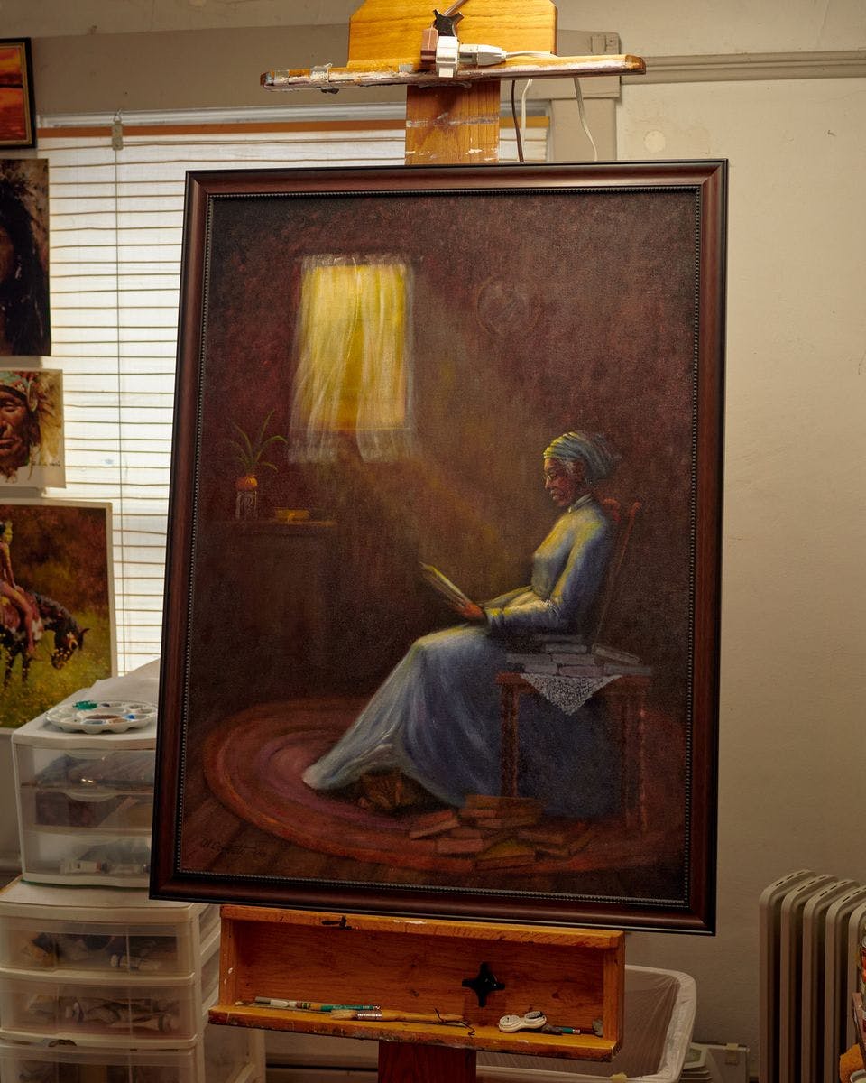 painting of a woman in front of window reading